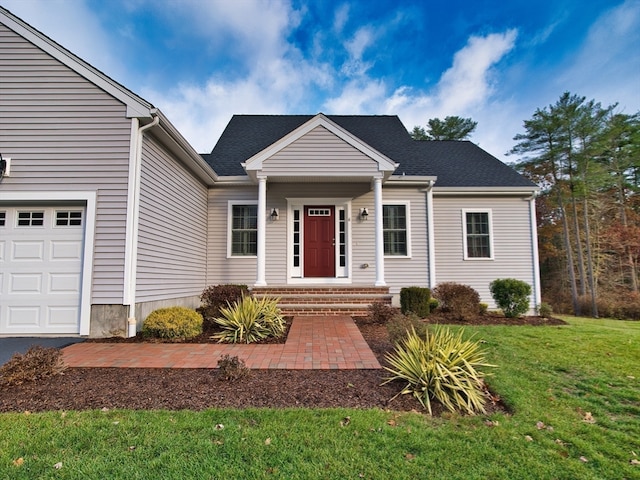 view of front of property with a garage and a front lawn