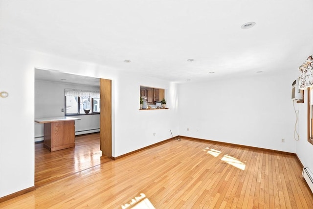 unfurnished living room featuring light wood-style floors, a baseboard radiator, baseboards, and baseboard heating