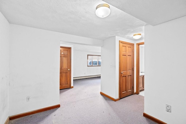 bonus room with carpet floors, baseboards, a textured ceiling, and baseboard heating