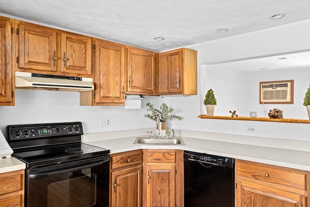 kitchen with a wall unit AC, black appliances, under cabinet range hood, and light countertops