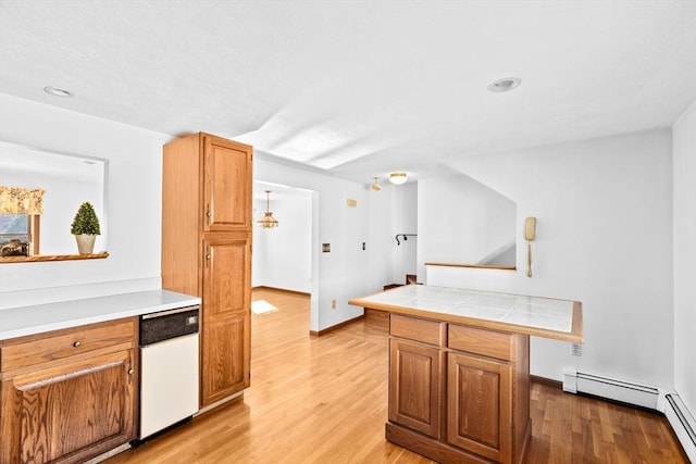 kitchen featuring tile countertops, a baseboard heating unit, brown cabinetry, and light wood-style flooring