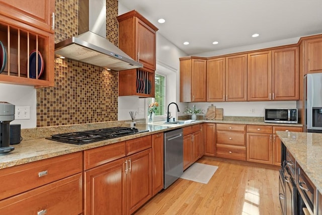 45 Anselm Way, Sudbury, MA 01776 - kitchen featuring wall chimney range hood, appliances with stainless steel finishes, light wood-style floors, light stone countertops, and a sink