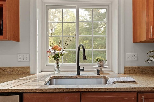 45 Anselm Way, Sudbury, MA 01776 - kitchen view of brown cabinetry, a sink, and light stone counters