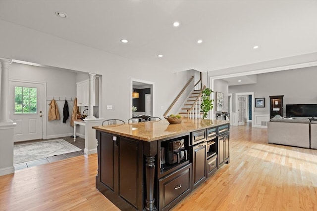 45 Anselm Way, Sudbury, MA 01776 - kitchen featuring ornate columns, light wood finished floors, open floor plan, light stone countertops, and recessed lighting