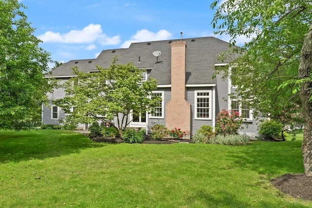 45 Anselm Way, Sudbury, MA 01776 - rear view of house featuring a lawn, a chimney, and a shingled roof