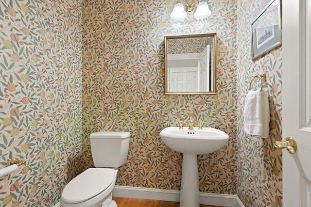 45 Anselm Way, Sudbury, MA 01776 - half bath featuring wallpapered walls, toilet, a chandelier, baseboards, and wood finished floors
