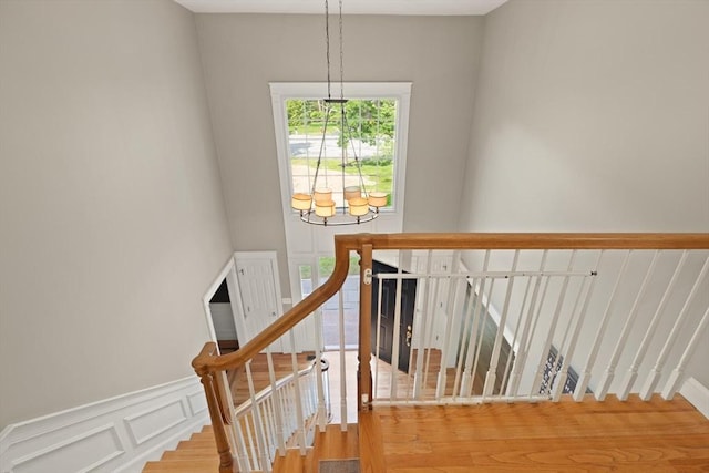 45 Anselm Way, Sudbury, MA 01776 - stairway featuring wainscoting, a decorative wall, and wood finished floors