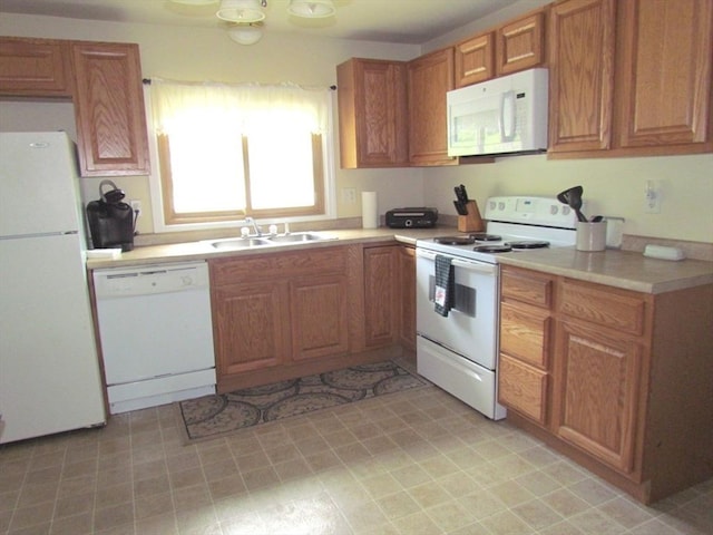 471 Mechanic St, Fitchburg, MA 01420 - kitchen featuring white appliances, a sink, light countertops, and brown cabinetry