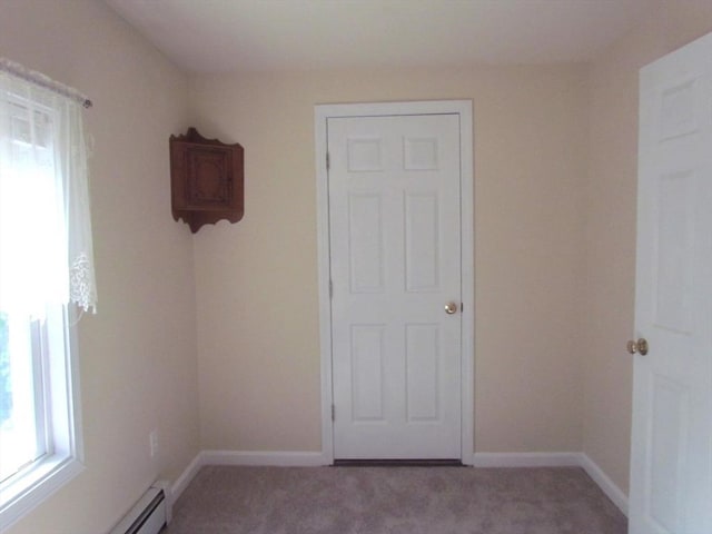471 Mechanic St, Fitchburg, MA 01420 - empty room featuring plenty of natural light, carpet floors, baseboards, and baseboard heating