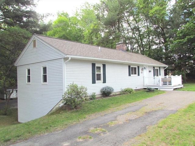 471 Mechanic St, Fitchburg, MA 01420 - single story home with a chimney, a wooden deck, and roof with shingles