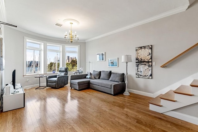 5 Brigham St Unit 1, Boston, MA 02128 - living room with ornamental molding, a chandelier, wood finished floors, baseboards, and stairs