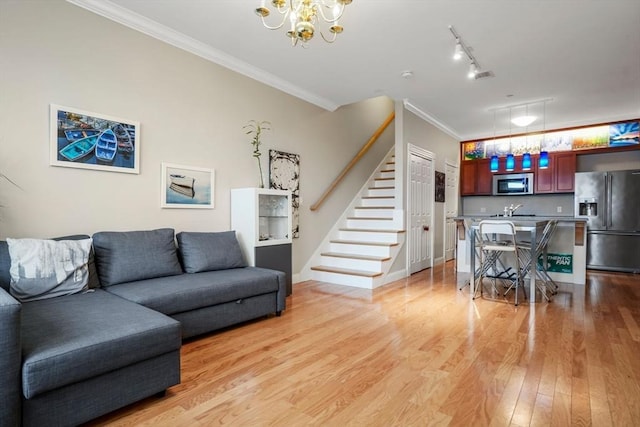 5 Brigham St Unit 1, Boston, MA 02128 - living area with a chandelier, stairway, light wood-type flooring, ornamental molding, and rail lighting