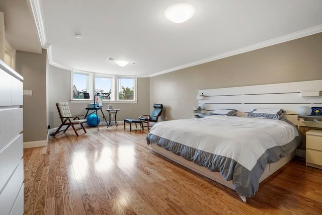 5 Brigham St Unit 1, Boston, MA 02128 - bedroom with ornamental molding, wood finished floors, and baseboards