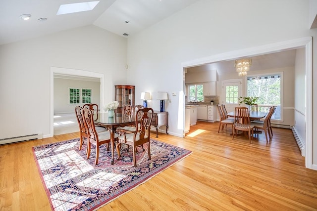 18 Curve Hill Rd, Yarmouth, MA 02664 - dining area featuring a chandelier, plenty of natural light, light wood finished floors, a skylight, and high vaulted ceiling
