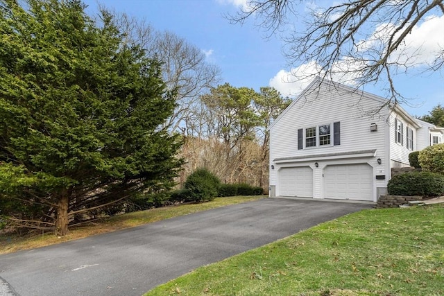 18 Curve Hill Rd, Yarmouth, MA 02664 - view of side of home with driveway, a garage, and a lawn