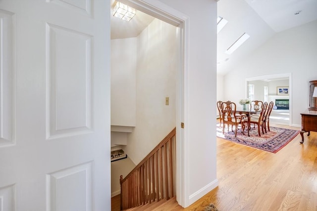 18 Curve Hill Rd, Yarmouth, MA 02664 - hall featuring light wood-type flooring, high vaulted ceiling, an upstairs landing, and a skylight