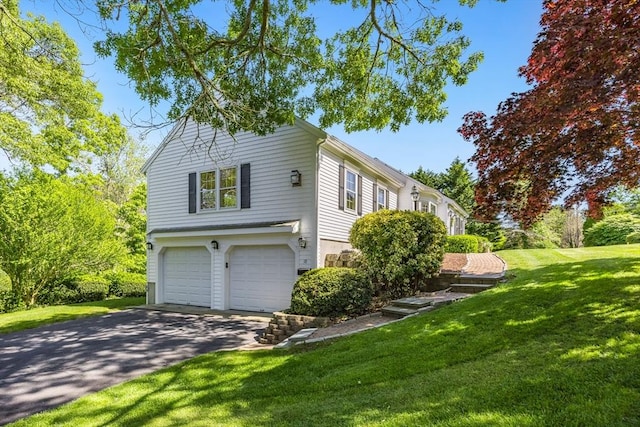 18 Curve Hill Rd, Yarmouth, MA 02664 - view of side of home featuring a garage, asphalt driveway, and a lawn