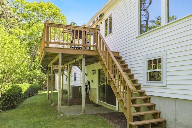 18 Curve Hill Rd, Yarmouth, MA 02664 - back of property with stairway, a yard, a deck, central AC unit, and a patio