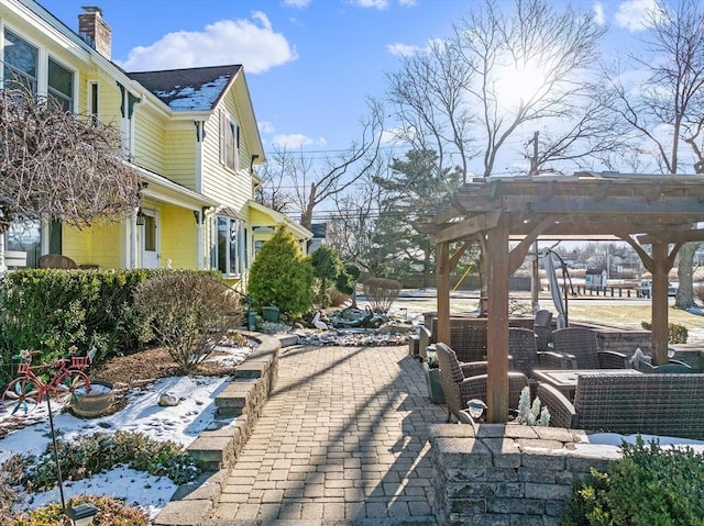 view of patio featuring an outdoor living space and a pergola