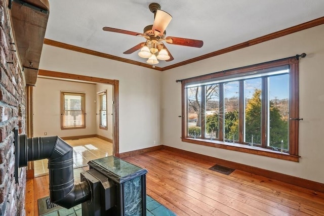 living room with ceiling fan, light hardwood / wood-style floors, and crown molding