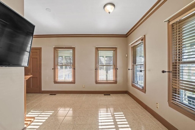 interior space with ornamental molding and light tile patterned flooring