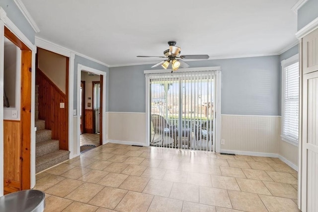 spare room with plenty of natural light, ceiling fan, light tile patterned floors, and crown molding