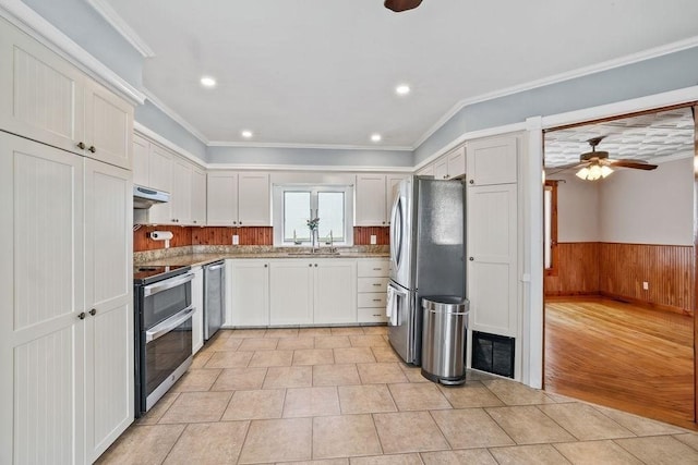 kitchen with crown molding, white cabinets, and appliances with stainless steel finishes