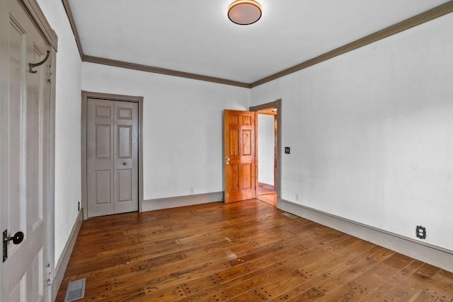 unfurnished room with hardwood / wood-style floors and ornamental molding