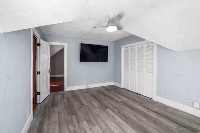 bonus room featuring a textured ceiling, hardwood / wood-style flooring, and ceiling fan