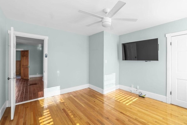 empty room with ceiling fan and wood-type flooring