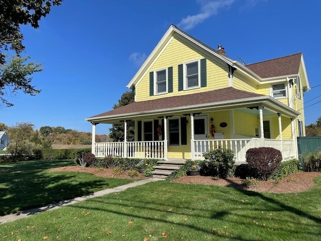 farmhouse with covered porch and a front yard