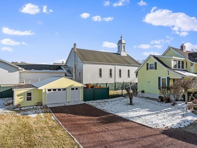 back of house featuring a balcony and a garage