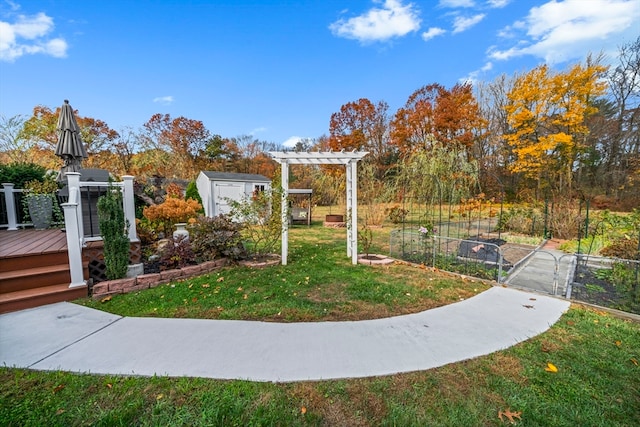 view of home's community with a storage unit, a deck, and a yard