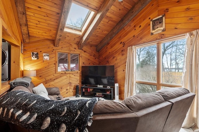 living area featuring vaulted ceiling with skylight, wood ceiling, and wood walls