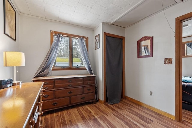 unfurnished bedroom with light wood-style flooring and baseboards