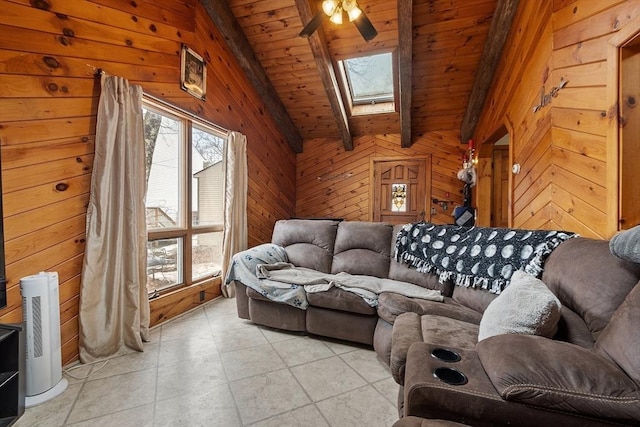 living room with a wealth of natural light, wood walls, vaulted ceiling with skylight, and wood ceiling