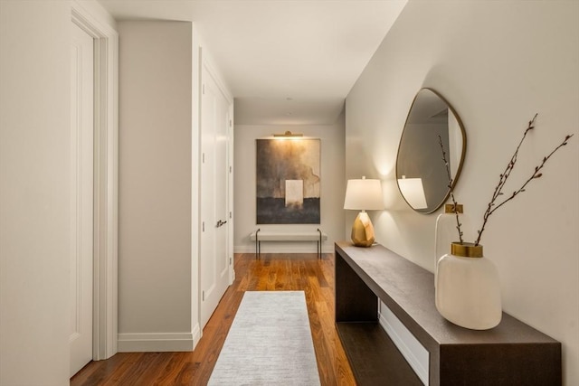 hallway with dark hardwood / wood-style flooring