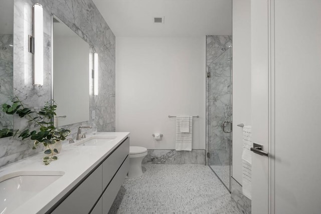 bathroom with vanity, radiator, a shower with door, and toilet