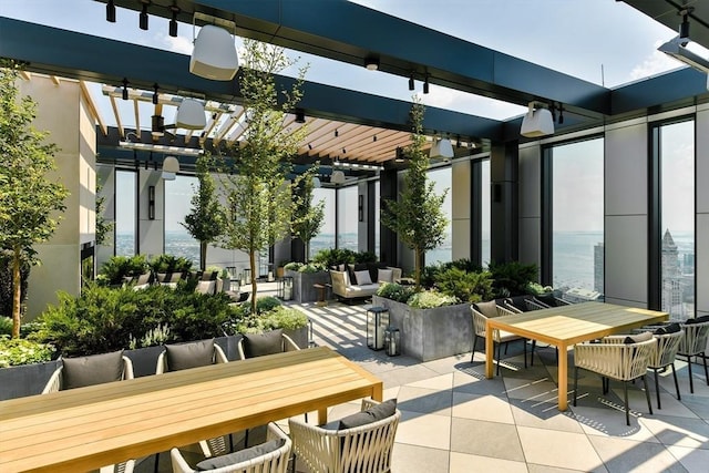 view of patio / terrace with a water view and a pergola