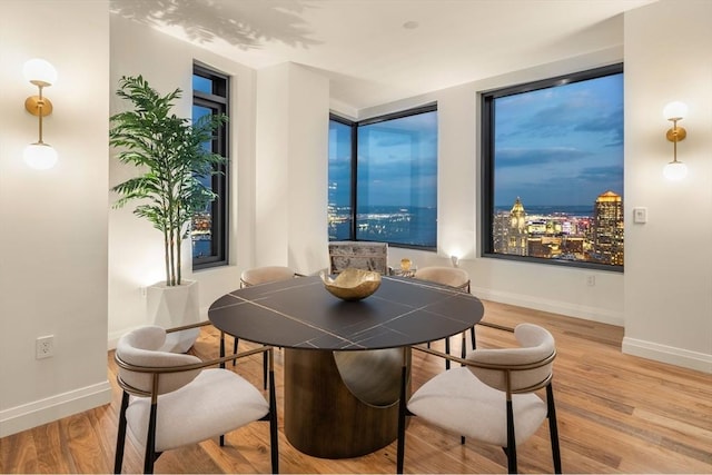 dining space with hardwood / wood-style flooring