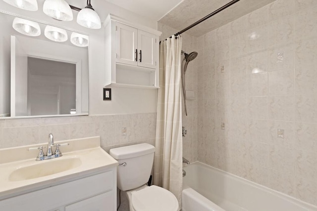 bathroom featuring toilet, tile walls, vanity, and shower / bath combination with curtain