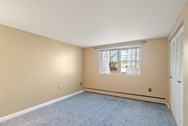 unfurnished bedroom with a closet, carpet flooring, baseboards, and baseboard heating