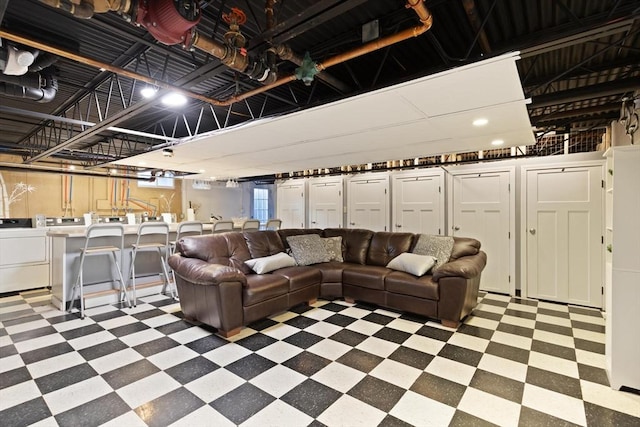 living area featuring tile patterned floors and independent washer and dryer