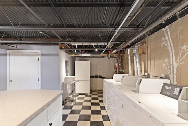 clothes washing area featuring tile patterned floors and separate washer and dryer