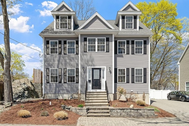 view of front of property featuring entry steps and fence
