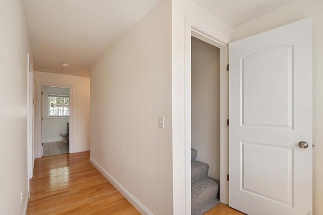 hallway with baseboards and light wood-style floors
