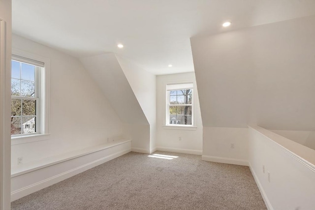 additional living space with lofted ceiling, carpet, a healthy amount of sunlight, and recessed lighting
