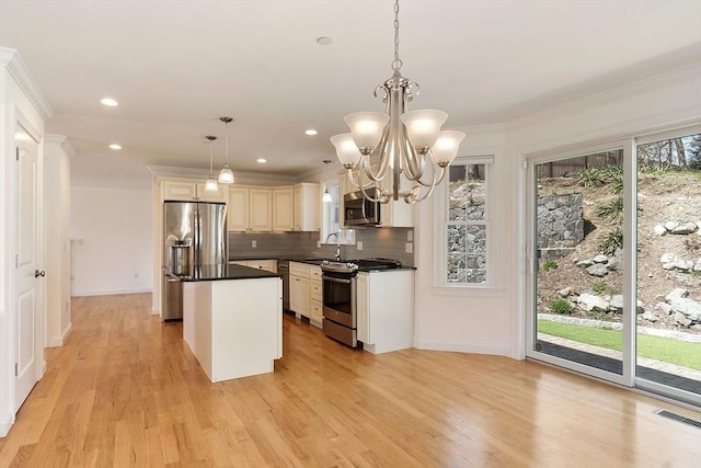 kitchen featuring a sink, a center island, backsplash, dark countertops, and appliances with stainless steel finishes