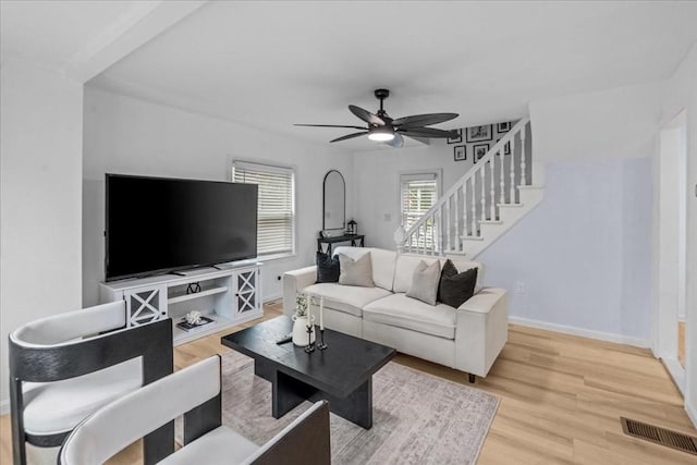 living room featuring light wood-type flooring and ceiling fan