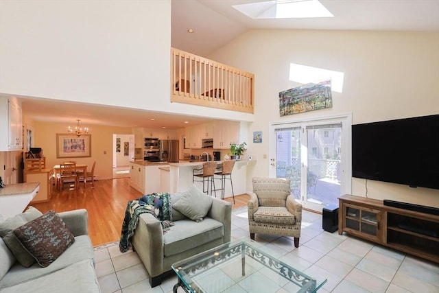8 Fieldstone Ln, Natick, MA 01760 - living room featuring a skylight, high vaulted ceiling, light tile patterned floors, and a chandelier